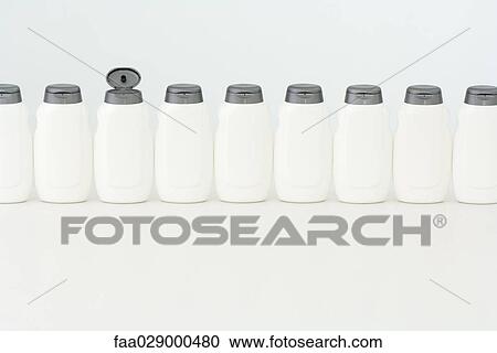 Line of bottles, one open View Large Photo Image Stock Image - Line of bottles, one open. Fotosearch