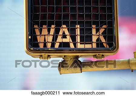Stock Image - Lit pedestrian walk sign, close-up. Fotosearch