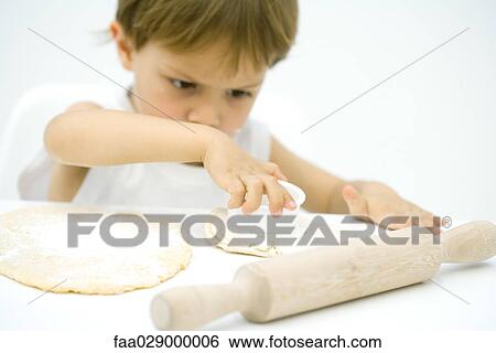 Little boy cutting out shape in dough View Large Photo Image Stock Photograph - Little boy cutting out shape in dough. Fotosearch