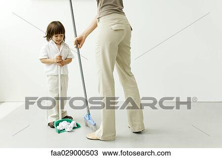 Little boy helping his mother sweep the floor, cropped view View Large Photo Image Stock Image - Little boy helping his mother sweep the floor, cropped view. Fotosearch