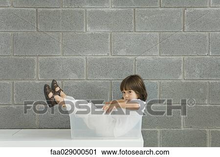 Little boy sitting inside plastic storage container, side view View Large Photo Image Stock Image - Little boy sitting inside plastic storage container, side view. Fotosearch