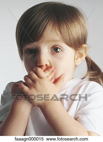Little girl covering mouth, portrait View Large Photo Image Stock Photography - Little girl covering mouth, portrait. Fotosearch
