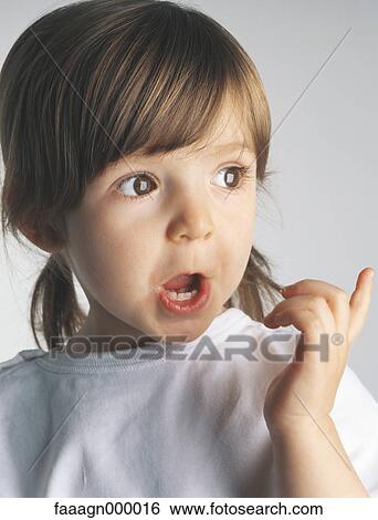 Little girl making face and pointing, portrait View Large Photo Image Stock Photograph - Little girl making face and pointing, portrait. Fotosearch