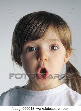 Stock Image - Little girl making face, portrait. Fotosearch