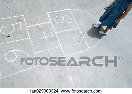 Little girl standing on hopscotch grid, high angle view, cropped View Large Photo Image Picture - Little girl standing on hopscotch grid, high angle view, cropped. Fotosearch