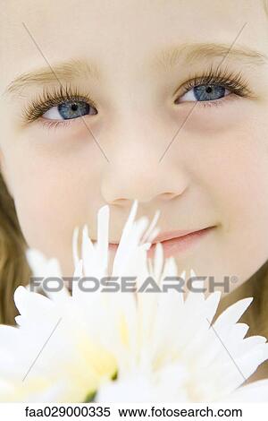 Little girl with flowers, looking up, smiling, portrait View Large Photo Image Stock Photography - Little girl with flowers, looking up, smiling, portrait. Fotosearch
