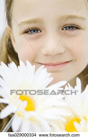 Little girl with gerbera daisies, smiling at camera, portrait View Large Photo Image Picture - Little girl with gerbera daisies, smiling at camera, portrait. Fotosearch