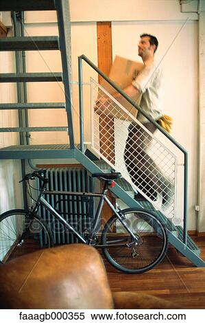 Man carrying box up stairs View Large Photo Image Stock Photography - Man carrying box up stairs. Fotosearch