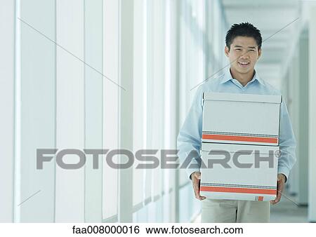 Man carrying boxes in hallway View Large Photo Image Stock Photograph - Man carrying boxes in hallway. Fotosearch
