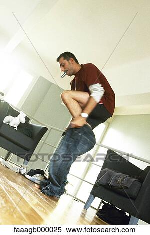 Stock Photography - Man getting dressed. Fotosearch