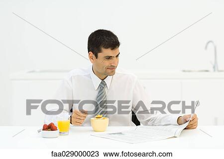 Man having breakfast in kitchen and reading newspaper View Large Photo Image Stock Image - Man having breakfast in kitchen and reading newspaper. Fotosearch