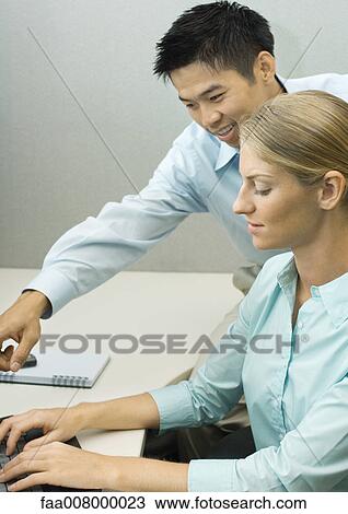 Man helping female colleague View Large Photo Image Stock Image - Man helping female colleague. Fotosearch