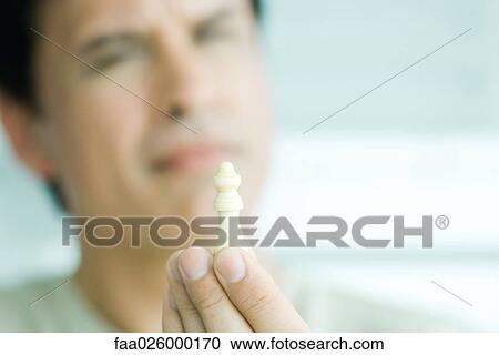 Man holding chess piece, focus on foreground View Large Photo Image Stock Image - Man holding chess piece, focus on foreground. Fotosearch