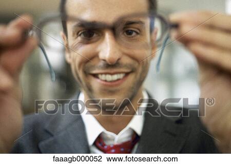 Man holding out glasses View Large Photo Image Stock Image - Man holding out glasses. Fotosearch