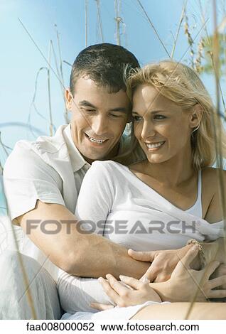 Man holding woman in dune grass View Large Photo Image Stock Image - Man holding woman in dune grass. Fotosearch
