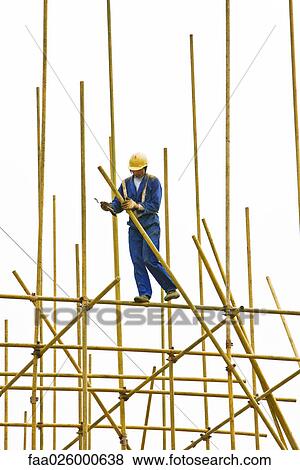 Man in hard hat assembling scaffolding View Large Photo Image Stock Photo - Man in hard hat assembling scaffolding. Fotosearch