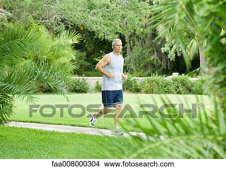 Man jogging in park View Large Photo Image Picture - Man jogging in park. Fotosearch