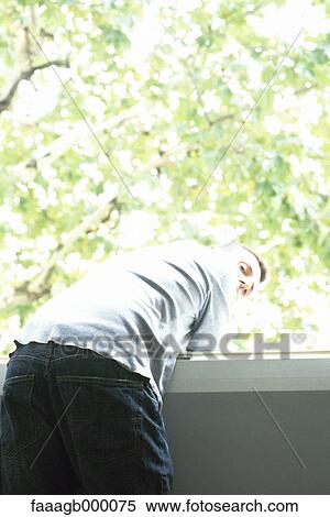 Man leaning over balacony, looking over shoulder View Large Photo Image Stock Photography - Man leaning over balacony, looking over shoulder. Fotosearch