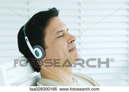 Man listening to headphones, eyes closed, profile View Large Photo Image Stock Photograph - Man listening to headphones, eyes closed, profile. Fotosearch