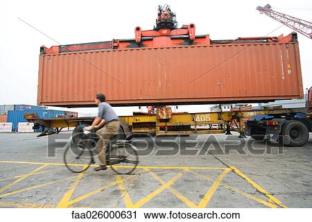 Man riding bicycle past truck and metal storage unit, side view View Large Photo Image Stock Image - Man riding bicycle past truck and metal storage unit, side view. Fotosearch