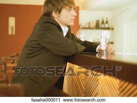 Man sitting at bar View Large Photo Image Stock Image - Man sitting at bar. Fotosearch