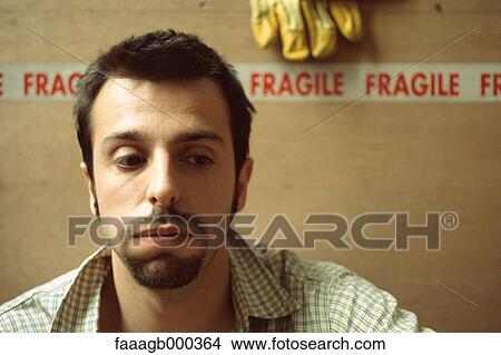 Man sitting in front of cardboard boxes View Large Photo Image Picture - Man sitting in front of cardboard boxes. Fotosearch