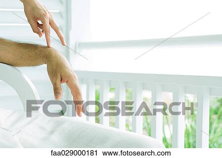Man sitting on porch, woman touching his arm with fingers, cropped view View Large Photo Image Stock Image - Man sitting on porch, woman touching his arm with fingers, cropped view. Fotosearch