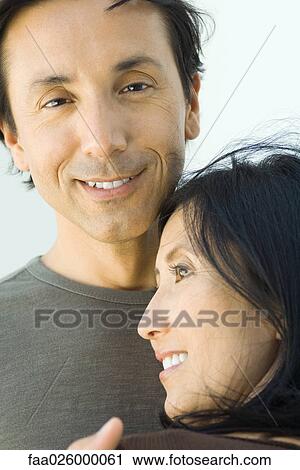Man smiling at camera as woman leans her head on his chest View Large Photo Image Stock Image - Man smiling at camera as woman leans her head on his chest. Fotosearch