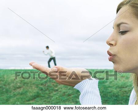 Man standing on woman's hand, optical illusion View Large Photo Image Stock Photo - Man standing on woman's hand, optical illusion. Fotosearch