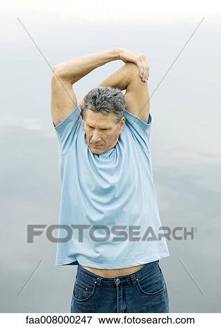 Man stretching outdoors View Large Photo Image Stock Photo - Man stretching outdoors. Fotosearch