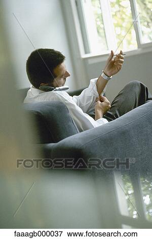Man talking on cell phone and buttoning sleeves View Large Photo Image Stock Photo - Man talking on cell phone and buttoning sleeves. Fotosearch