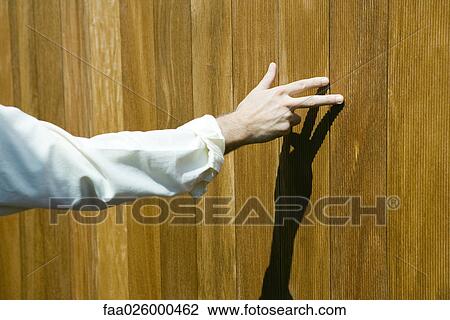 Man touching wood paneling with fingers, cropped view View Large Photo Image Stock Image - Man touching wood paneling with fingers, cropped view. Fotosearch