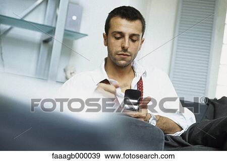 Man using cell phone View Large Photo Image Stock Photo - Man using cell phone. Fotosearch