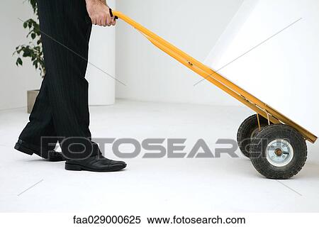 Man using pallet truck to move box, side view, cropped View Large Photo Image Stock Photography - Man using pallet truck to move box, side view, cropped. Fotosearch