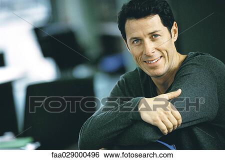 Man with arms folded, smiling at camera, portrait View Large Photo Image Stock Photograph - Man with arms folded, smiling at camera, portrait. Fotosearch
