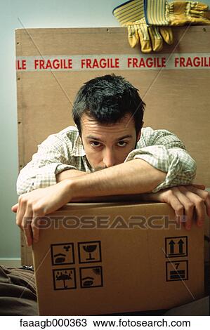 Stock Image - Man with cardboard boxes. Fotosearch