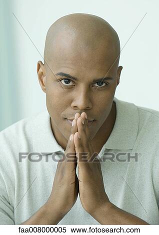 Man with hands together, looking at camera View Large Photo Image Stock Photography - Man with hands together, looking at camera. Fotosearch