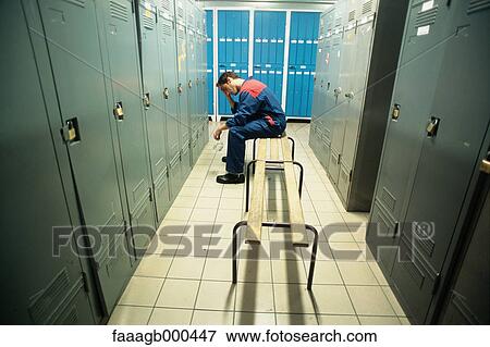 Stock Photo - Manual worker in locker room. Fotosearch