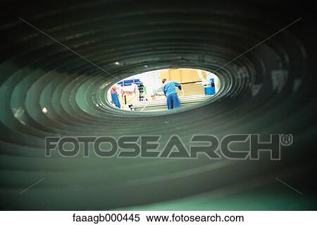 Manual worker, seen through tube View Large Photo Image Stock Photography - Manual worker, seen through tube. Fotosearch