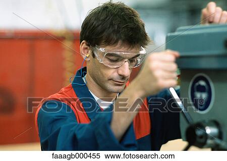 Manual worker using drill machine View Large Photo Image Stock Photography - Manual worker using drill machine. Fotosearch