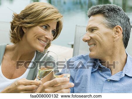 Mature couple clinking champagne glasses View Large Photo Image Stock Image - Mature couple clinking champagne glasses. Fotosearch
