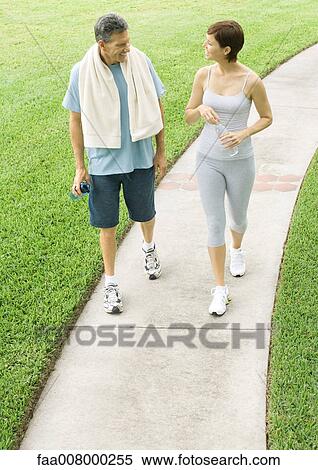 Mature couple walking on path after workout View Large Photo Image Stock Photography - Mature couple walking on path after workout. Fotosearch