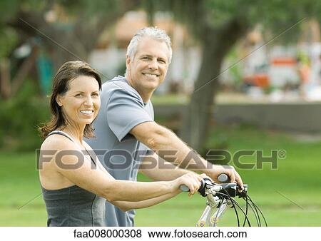 Mature couple with bikes, portrait View Large Photo Image Stock Photo - Mature couple with bikes, portrait. Fotosearch