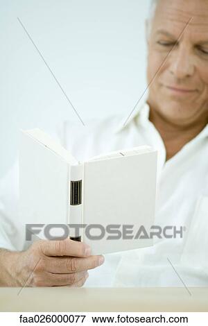 Mature man reading book, cropped view View Large Photo Image Stock Photo - Mature man reading book, cropped view. Fotosearch