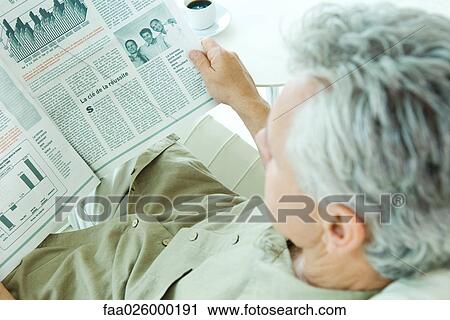 Mature man reading newspaper, over the shoulder view View Large Photo Image Stock Image - Mature man reading newspaper, over the shoulder view. Fotosearch