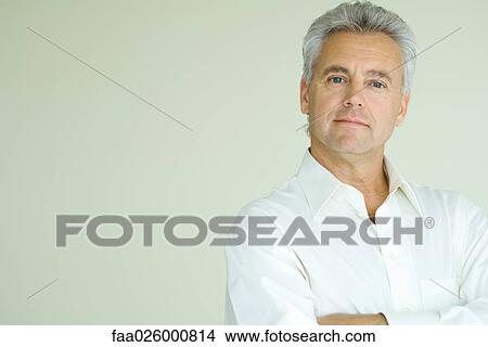 Mature man with arms folded, looking at camera, head and shoulders, portrait View Large Photo Image Picture - Mature man with arms folded, looking at camera, head and shoulders, portrait. Fotosearch