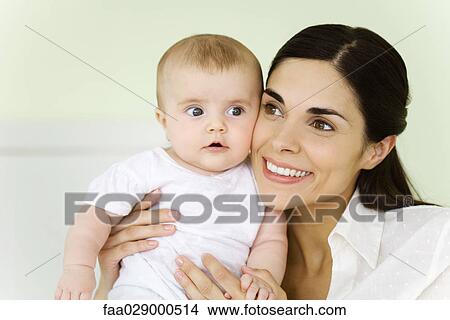 Mother holding infant, smiling, portrait View Large Photo Image Picture - Mother holding infant, smiling, portrait. Fotosearch