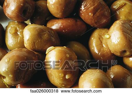 Olives in oil, extreme close-up View Large Photo Image Stock Photo - Olives in oil, extreme close-up. Fotosearch
