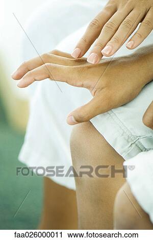 One hand reaching out to hold another hand, close-up View Large Photo Image Stock Image - One hand reaching out to hold another hand, close-up. Fotosearch