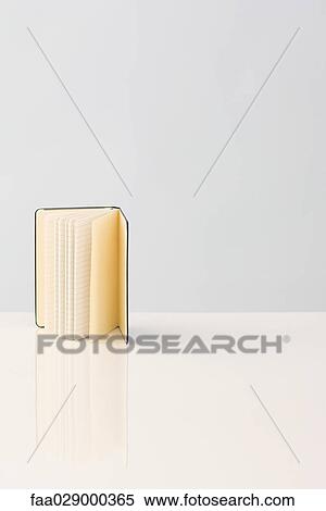 Open book with lined pages, standing on end View Large Photo Image Stock Photography - Open book with lined pages, standing on end. Fotosearch